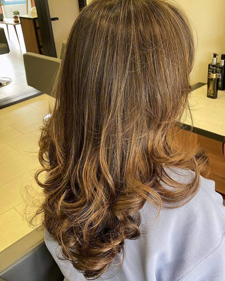 Media melena en capas con ondas y volumen, corte y estilo en Quito